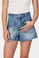 Woman wearing a white top and denim shorts on a white background